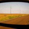 Road reflected in side-view mirror