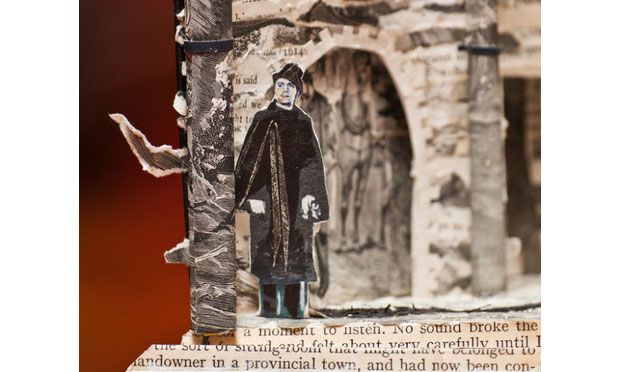 Book sculpture man standing outside