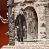 Book sculpture man standing outside