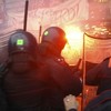 	Demonstrators (back), protesting against the Italian government's austerity budget cuts, clash with riot policemen outside La Scala