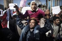 supporter of Egyptian President Hosni Mubarak carries his daughter ...