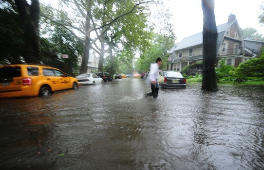 A man makes his way through a flooded street in Brooklyn, New York, August 28, 2011.