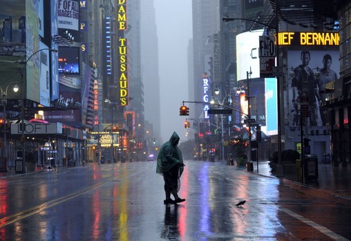A man walks across 42nd Street in Times Square in New York on August 28, 2011 as Hurricane Irene hits the city and Tri State area with rain and high winds.