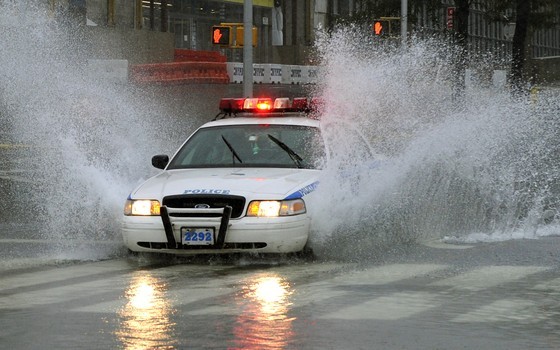 A New York City Police car drives through a flooded intersection on 43nd Street in New York on August 28, 2011 as Hurricane Irene hits the city and Tri State area with rain and high winds.