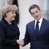French President Nicolas Sarkozy (R) shakes hand with German Chancellor Angela Merkel after their meeting at the Elysee palace on December 5, 2011 in Paris