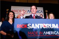 Rick Santorum speaks to supporters as his daughter, Elizabeth (L), and wife, Karen (R), look on February 7, 2012 at the St. Charles Convention Center in St. Charles, Missouri.