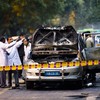 Police and forensic officers examine a damaged Israeli embassy vehicle after an explosion on February 13, 2012 in New Delhi, India.