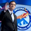 Republican presidential candidate Rick Santorum waves as he arrives to the debate hall on February 22, 2012 in Mesa, Arizona.