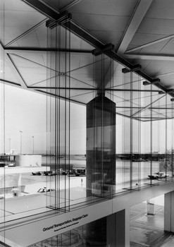 Glazed curtain wall with glass stabilizers with a view north toward the airfield.