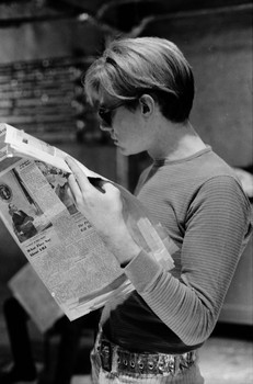 Andy Warhol reading the Village Voice in the Silver Factory, 1966. 