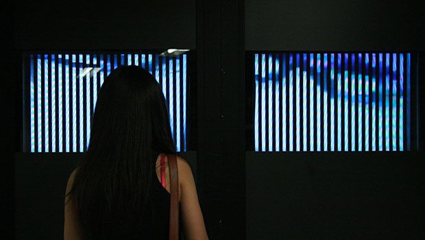 A commuter stops to gaze at the zoetrope, which has been installed in a vacant retail space outside the turnstiles below the Food Emporium escalator on 14th St. just east of Fourth Ave. 