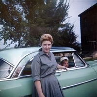 mom & me early 1960's with a green car