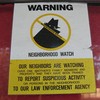 A neighborhood watch sign attached to a door.