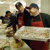 Rich Padula (R) holds a tray of carved turkey beside John Feeney (L) during Thanksgiving preparations at the Bowery Mission 23 November 2005 in New York. Founded in 1879, the facility is the third old