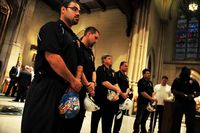 Construction workers at St. Patrick's Cathedral in honor of International Workers' Memorial Day.