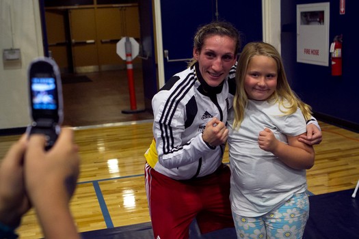 Julia Irman won the German National Championship three weeks after giving birth to her son. Here she poses with a young fan. “In a couple years I want to have another child. A girl. A boxer like me.”