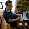 Kelly Sutton at his desk, amidst a few of his (few) remaining possessions