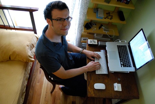 Kelly Sutton at his desk, amidst a few of his (few) remaining possessions