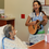 Danielle DeCosmo, an artist in residence at Shands, plays for a patient.