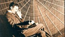 Nikola Tesla in front of the spiral coil of his high-frequency transformer in New York.
