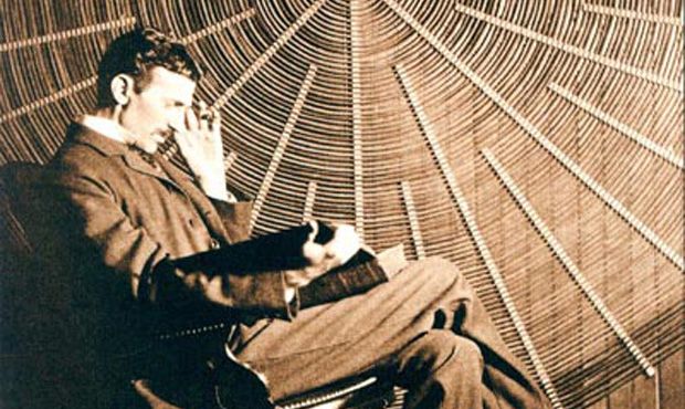 Nikola Tesla in front of the spiral coil of his high-frequency transformer in New York.