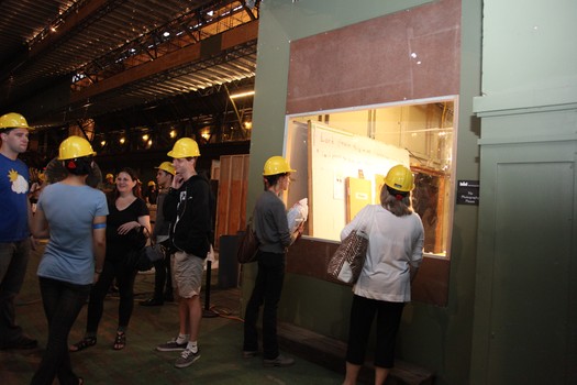 Visitors don hard hats to check out the open studio.