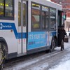 A city bus with chains fitted to the rear wheels travels its route in Brooklyn Wednesday morning.