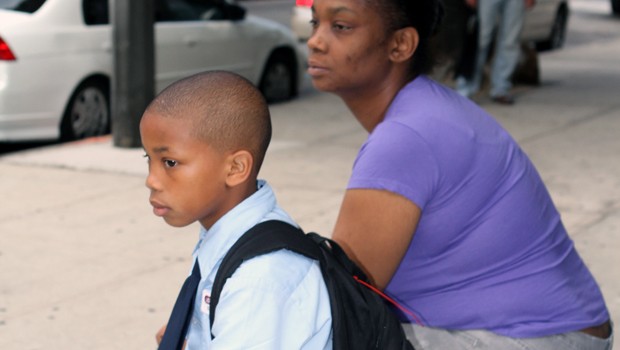 Jahlik and his mom Genevieve wait for Jahlik's bus to charter school.