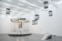 Carsten Höller's Mirror Carousel (left), Singing Canaries Mobile (top right), and Untitled (Slide) (bottom right) at the New Museum