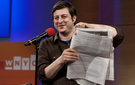 Eugene Mirman holds the full-page attack ad against Time Warner Cable he placed in The Greenpoint Gazette.
