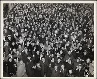 Crowd cheering and holding noise-makers, possibly on New Years, ca. 1945.