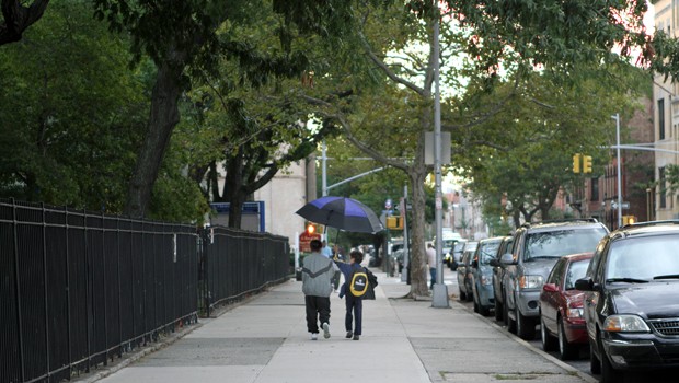 Michael and his mom Seyana Block share an umbrella on the way to school.