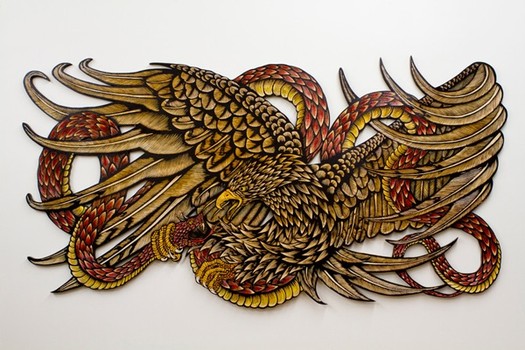 'Reaping Sun,' a hand-colored wood carving, also by McNett — an artist known for his intricate prints (some of which have ended up as street art in the past).