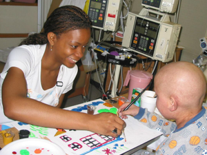 An art therapy student paints with a patient as part of Shands Hospital’s Arts in Healthcare program in Gainesville, Florida. Bringing the arts into hospital settings helps to humanize healthcare and 