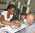 An art therapy student paints with a patient as part of Shands Hospital’s Arts in Healthcare program in Gainesville, Florida. Bringing the arts into hospital settings helps to humanize healthcare and 