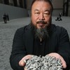 Chinese Artist Ai Weiwei holds some seeds from his Unilever Installation 'Sunflower Seeds' at The Tate Modern.