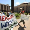 Protesters march past the Arizona State Capital Building as they campaign against the controversial state law SB1070