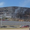 Smoke billows from a building that houses IRS offices after a small plane crashed into it February 18, 2010 in Austin, Texas.