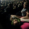 A two-month-old baby wears ear muffs for hearing protection while sleeping during the concert