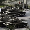 Bahraini army tanks take position near Pearl Square in Manama on February 17, 2011
