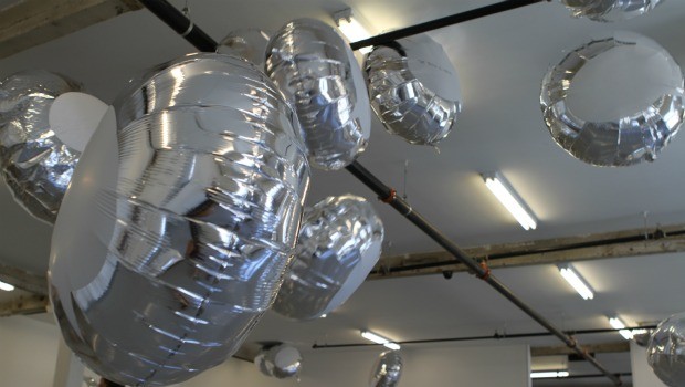 With the aid of several whooshing fans, the balloons whirl through the gallery.