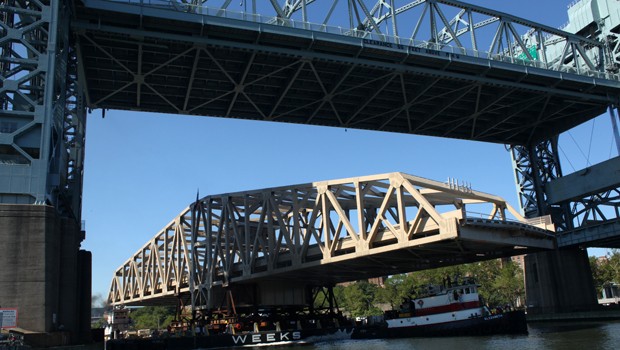 Barge passing under the 55-foot Robert F. Kennedy Bridge