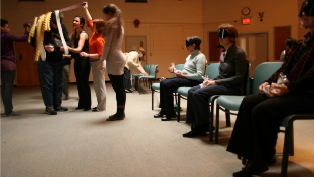 Blindfolded audience members are escorted under padded packing. At this moment, you have no idea where you're going or what you will hear next!