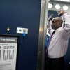 A Transportation Security Administration (TSA) volunteer demonstrates a full-body scanner at O'Hare International Airport 