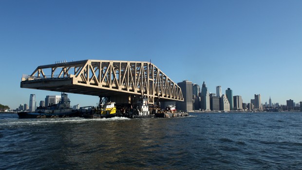 The barge is steered by two tugboats in the back