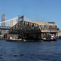 New Willis Avenue Bridge being transported upriver