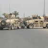 In this shot, Wilkens' squad fixes a broken down humvee in Baghdad.