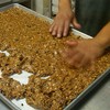 Pat-a-cake, pat-a-cake: Apricot Bum Bars, being prepared for their short trip through the oven.