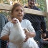 A young chicken fancier with her new friend in the South Bronx