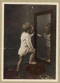 child looking into mirror